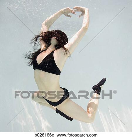 woman swimming underwater in a pool View Large Photo Image Stock Image - woman swimming underwater in a pool. Fotosearch