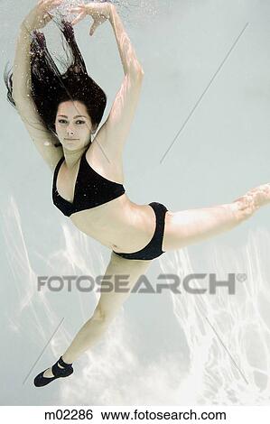 Stock Photograph - woman swimming underwater in a pool. Fotosearch