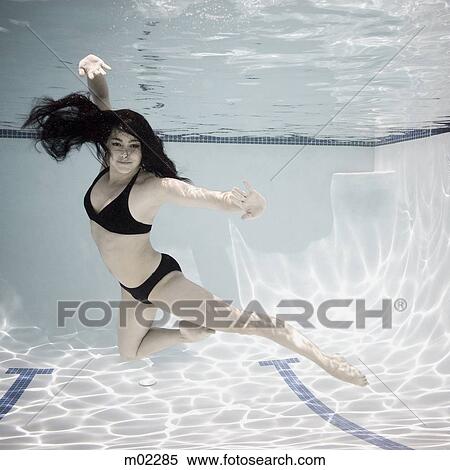woman swimming underwater in a pool View Large Photo Image Stock Photography - woman swimming underwater in a pool. Fotosearch