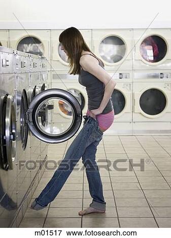 woman taking off her clothes at the laundromat View Large Photo Image Stock Photo - woman taking off her clothes at the laundromat. Fotosearch