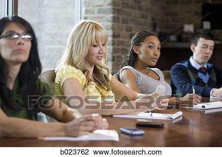 woman using her cell phone during a meeting View Large Photo Image Stock Image - woman using her cell phone during a meeting. Fotosearch