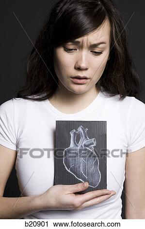 Woman with a drawing of a heart View Large Photo Image Stock Image - Woman with a drawing of a heart. Fotosearch