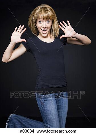 Young cheerful woman jumping, studio shot View Large Photo Image Picture - Young cheerful woman jumping, studio shot. Fotosearch