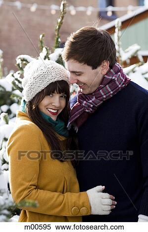 Stock Photography - young couple together in the snow. Fotosearch