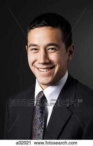 Stock Image - Young elegant man smiling, portrait, close-up. Fotosearch