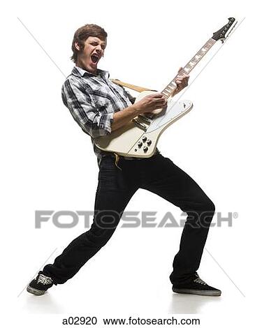 Stock Image - Young man playing electric guitar, shouting. Fotosearch