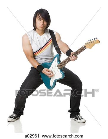 Stock Image - Young man playing electric guitar, portrait. Fotosearch