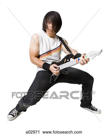 Young man playing guitar video game, portrait View Large Photo Image Stock Image - Young man playing guitar video game, portrait. Fotosearch