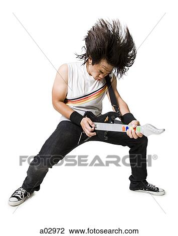 Young man playing guitar video game, portrait View Large Photo Image Stock Image - Young man playing guitar video game, portrait. Fotosearch