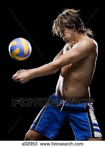 Stock Image - Young man receiving volleyball. Fotosearch