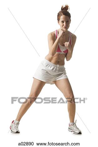 Stock Image - Young woman doing boxing moves, studio shot. Fotosearch