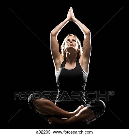 Young woman doing yoga, studio shot View Large Photo Image Stock Image - Young woman doing yoga, studio shot. Fotosearch
