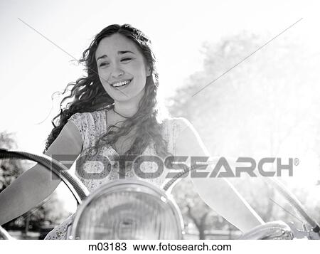 Young woman driving motorcycle View Large Photo Image Stock Image - Young woman driving motorcycle. Fotosearch