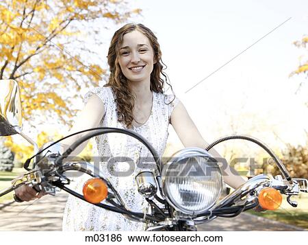 Young woman driving motorcycle View Large Photo Image Stock Photograph - Young woman driving motorcycle. Fotosearch
