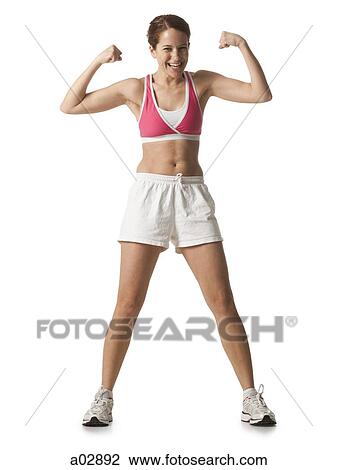Young woman flexing her muscles, studio shot View Large Photo Image Stock Image - Young woman flexing her muscles, studio shot. Fotosearch