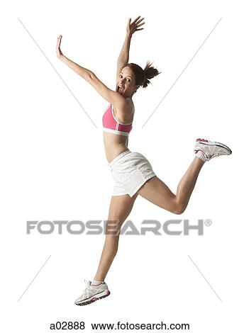 Young woman jumping in the air, studio shot View Large Photo Image Stock Photo - Young woman jumping in the air, studio shot. Fotosearch