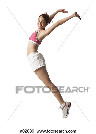 Young woman jumping in the air, studio shot View Large Photo Image Stock Photo - Young woman jumping in the air, studio shot. Fotosearch