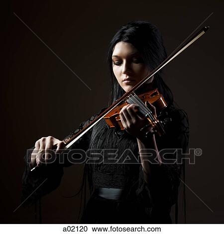 Young woman playing violin, studio shot View Large Photo Image Stock Image - Young woman playing violin, studio shot. Fotosearch
