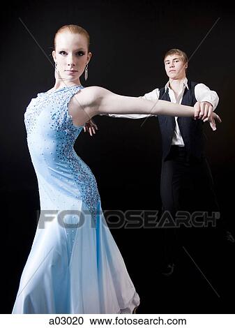Young woman posing with teenage boy (16-17) as two professional dancers, studio shot View Large Photo Image Stock Image - Young woman posing with teenage boy (16-17) as two professional dancers, studio shot. Fotosearch