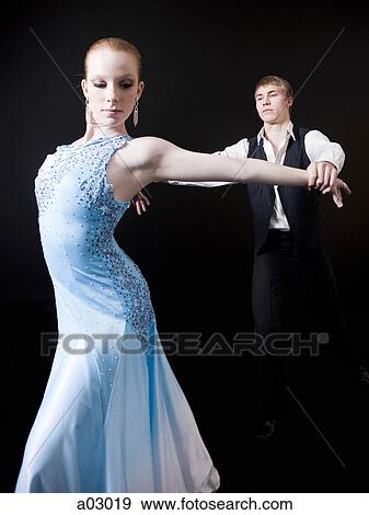Young woman posing with teenage boy (16-17) as two professional dancers, studio shot View Large Photo Image Stock Photo - Young woman posing with teenage boy (16-17) as two professional dancers, studio shot. Fotosearch
