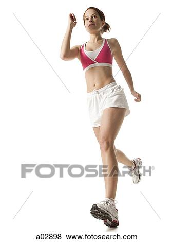 Stock Photo - Young woman power walking, studio shot. Fotosearch
