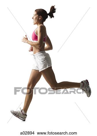 Picture - Young woman running, studio shot. Fotosearch