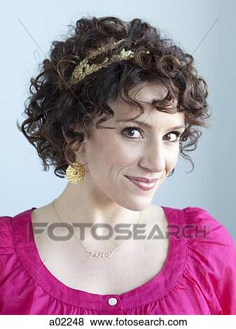 Young woman smiling, portrait, studio shot View Large Photo Image Stock Photo - Young woman smiling, portrait, studio shot. Fotosearch