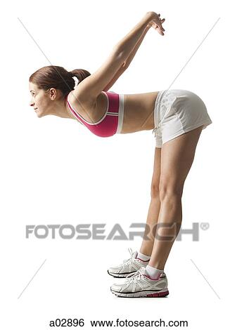 Young woman stretching, studio shot View Large Photo Image Stock Photograph - Young woman stretching, studio shot. Fotosearch