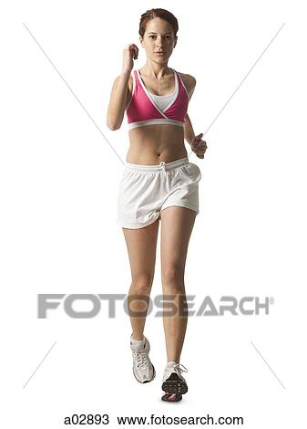 Stock Image - Young woman walking for exercise, studio shot. Fotosearch