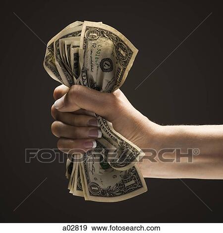Young woman's hand holding a wad of US one dollar bills View Large Photo Image Stock Photo - Young woman's hand holding a wad of US one dollar bills. Fotosearch