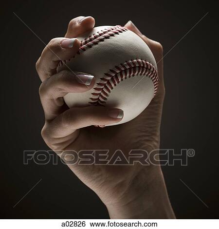 Young woman's hand holding baseball View Large Photo Image Stock Photograph - Young woman's hand holding baseball. Fotosearch