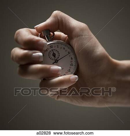 Young woman's hand holding stop clock View Large Photo Image Stock Photo - Young woman's hand holding stop clock. Fotosearch