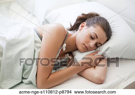 Picture - Attractive young woman sleeping in bed. Fotosearch