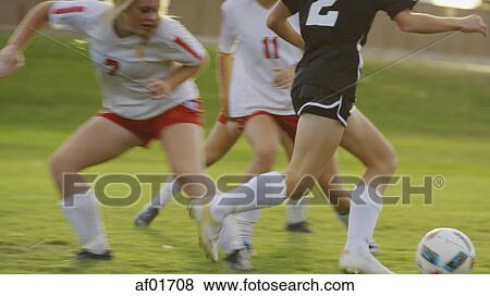 Blurred view of athlete with soccer teammates kicking ball on field View Large Photo Image Stock Photo - Blurred view of athlete with soccer teammates kicking ball on field. Fotosearch