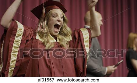 Stock Photo - Blurred view of cheering student on stage during graduation ceremony. Fotosearch