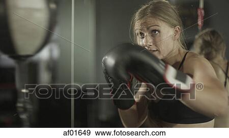 Blurred view of female boxer working out and training with punching ball in gym View Large Photo Image Stock Photo - Blurred view of female boxer working out and training with punching ball in gym. Fotosearch
