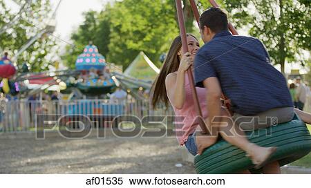 Blurred view of laughing happy boyfriend and girlfriend playing on tire swing in park View Large Photo Image Stock Photography - Blurred view of laughing happy boyfriend and girlfriend playing on tire swing in park. Fotosearch