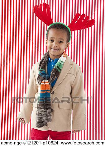 Boy (4-5) wearing reindeer antlers, studio shot View Large Photo Image Picture - Boy (4-5) wearing reindeer antlers, studio shot. Fotosearch