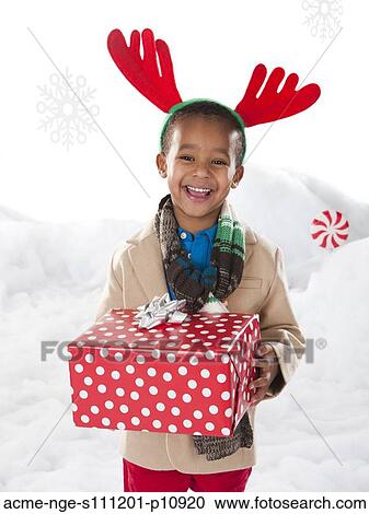 Boy holding a christmas gift. View Large Photo Image Stock Image - Boy holding a christmas gift.. Fotosearch