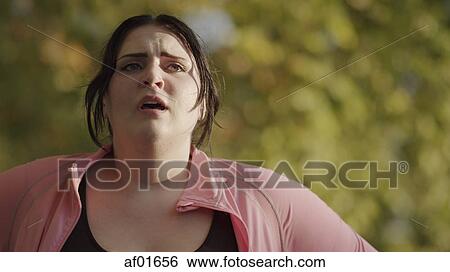 Close up of exhausted woman resting and working out outdoors View Large Photo Image Stock Photograph - Close up of exhausted woman resting and working out outdoors. Fotosearch