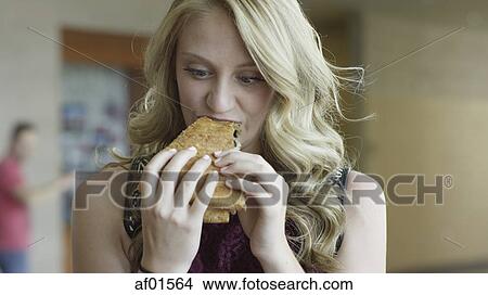 Close up of hungry woman eating delicious pizza View Large Photo Image Picture - Close up of hungry woman eating delicious pizza. Fotosearch