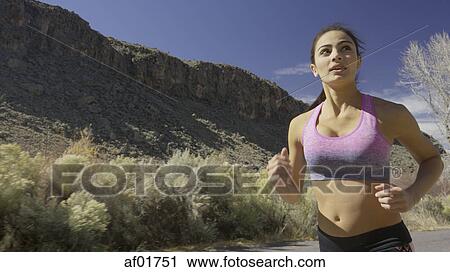 Close up of serene runner jogging in remote forest landscape View Large Photo Image Stock Image - Close up of serene runner jogging in remote forest landscape. Fotosearch