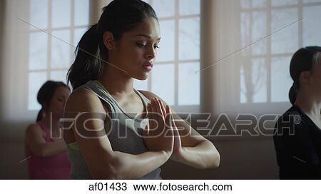 Close up of serene woman meditating in yoga class View Large Photo Image Stock Image - Close up of serene woman meditating in yoga class. Fotosearch
