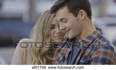 Close up of smiling boyfriend and girlfriend relaxing outdoors View Large Photo Image Stock Photograph - Close up of smiling boyfriend and girlfriend relaxing outdoors. Fotosearch