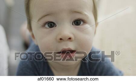 Close up portrait of adorable inquisitive baby boy looking up View Large Photo Image Stock Image - Close up portrait of adorable inquisitive baby boy looking up. Fotosearch