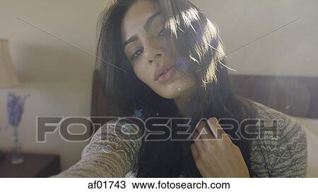 Close up portrait of sultry woman posing and sitting on bed View Large Photo Image Stock Image - Close up portrait of sultry woman posing and sitting on bed. Fotosearch