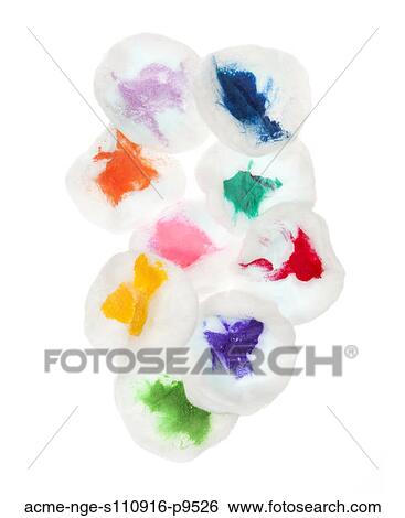 Stock Photograph - Cotton pads stained with colorful paint on white background. Fotosearch