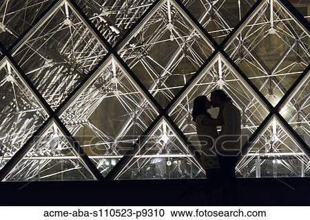 France, Paris, The Louvre, Couple kissing in front of glass pyramid View Large Photo Image Stock Image - France, Paris, The Louvre, Couple kissing in front of glass pyramid. Fotosearch