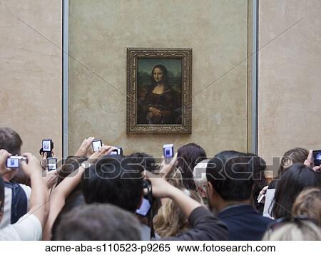 Stock Photography - France, Paris, Tourists photographing Mona Lisa painting. Fotosearch