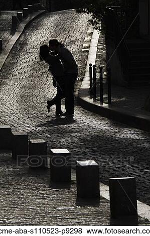France, Paris, Young couple kissing on cobblestoned street View Large Photo Image Stock Photo - France, Paris, Young couple kissing on cobblestoned street. Fotosearch